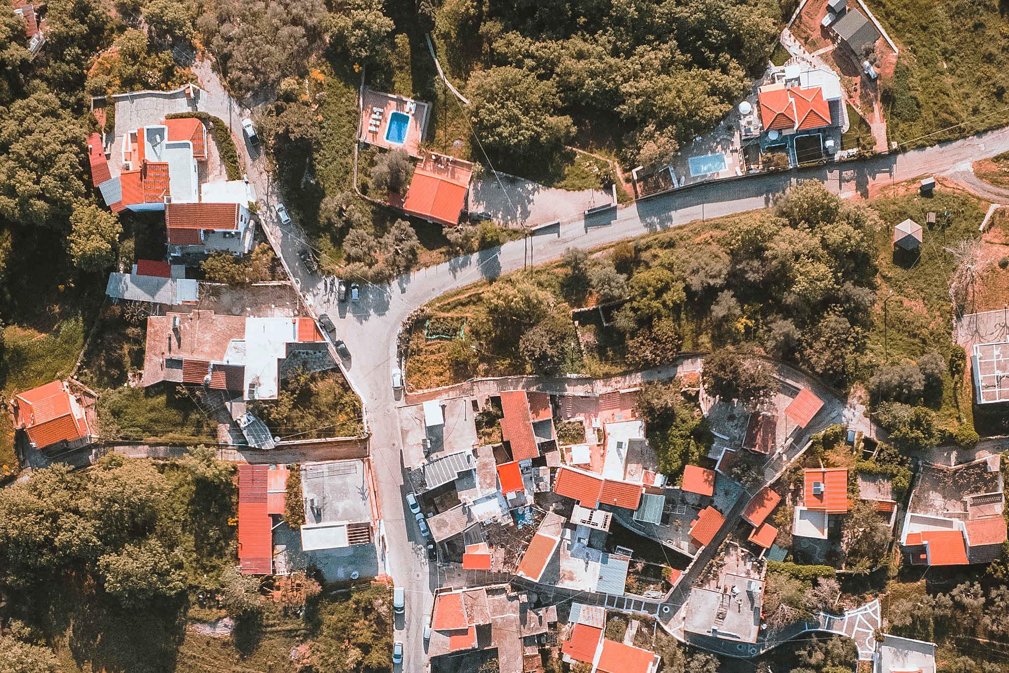 Aerial view of Kastellos village, Rethymno, its terracotta rooftops set among olive groves