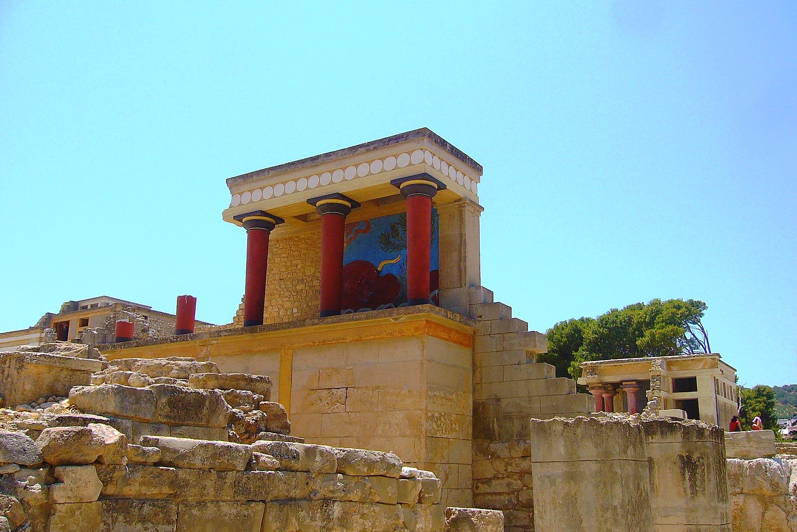 The restored north entrance of the Palace of Knossos, with its red columns and the charging bull fresco