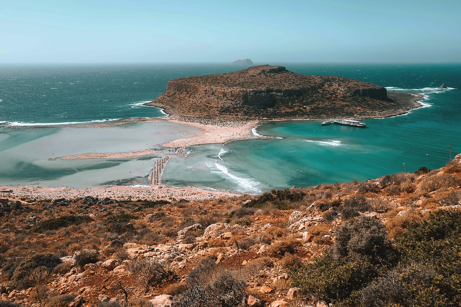 The turquoise lagoon at Balos seen from the hillside path, with the Gramvousa peninsula beyond
