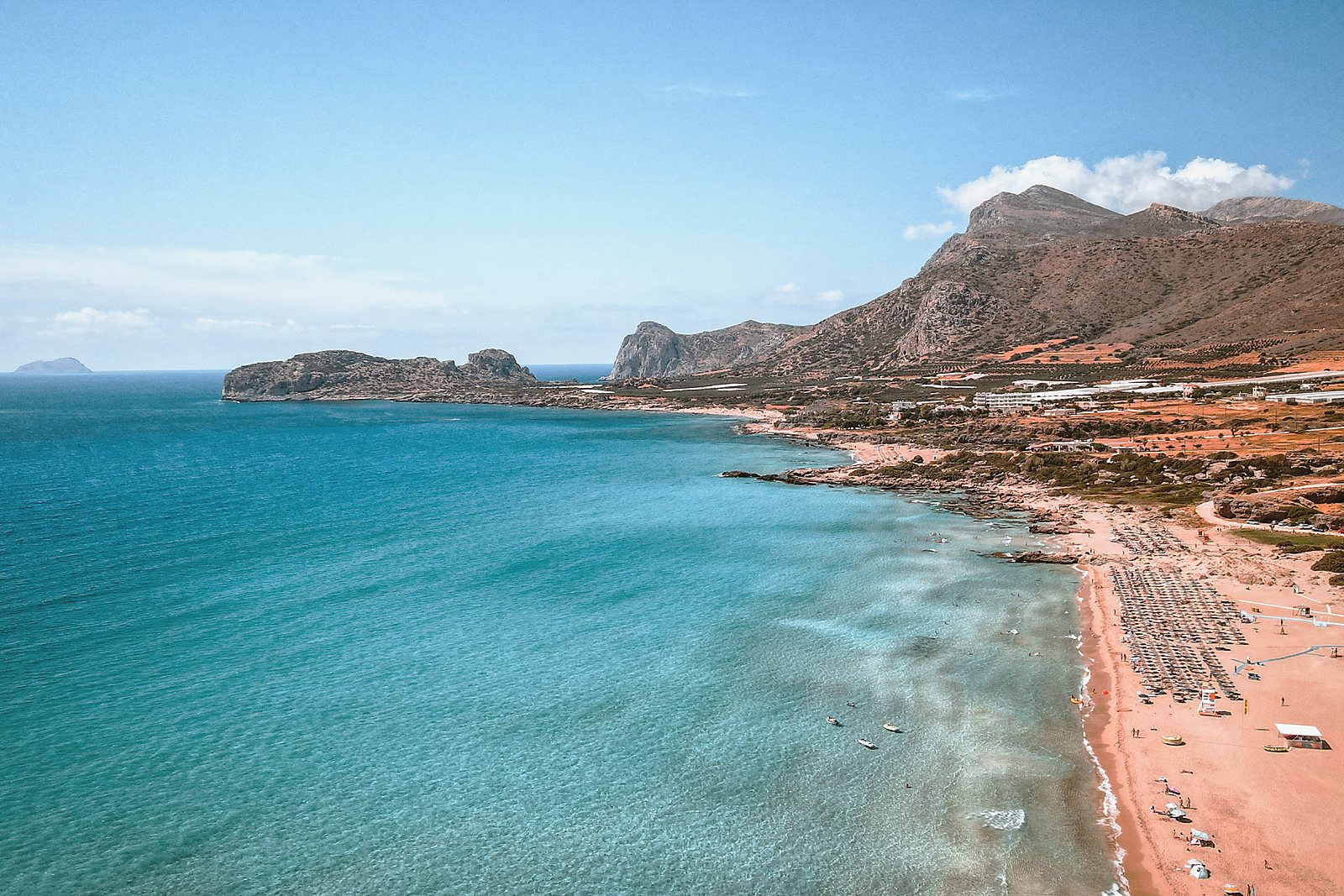 The long sweep of Falassarna beach on the west coast, with turquoise shallows and the headland beyond