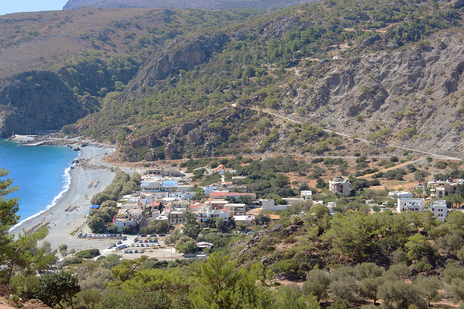 Sougia seen from the hillside above, its pebble beach and small village set between the mountains and the Libyan Sea